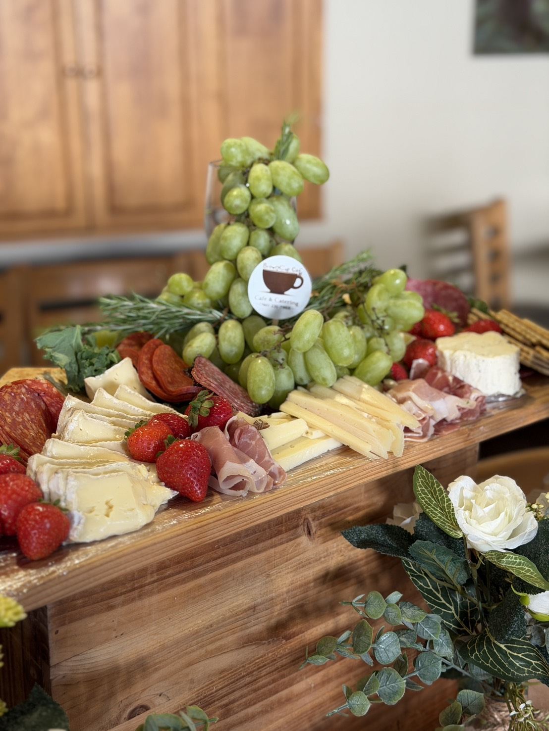 Charcuterie board with brie, prosciutto, salami, strawberries and grapes