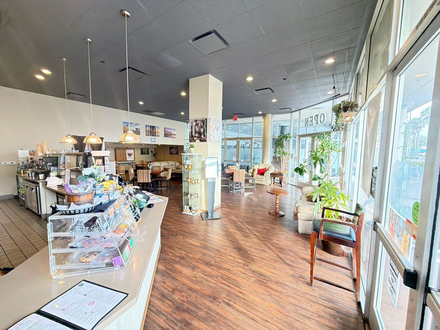 The bright main room at Brown Cup Cafe with couches and big street-facing windows